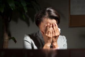Frustrated and disappointed business woman with a headache